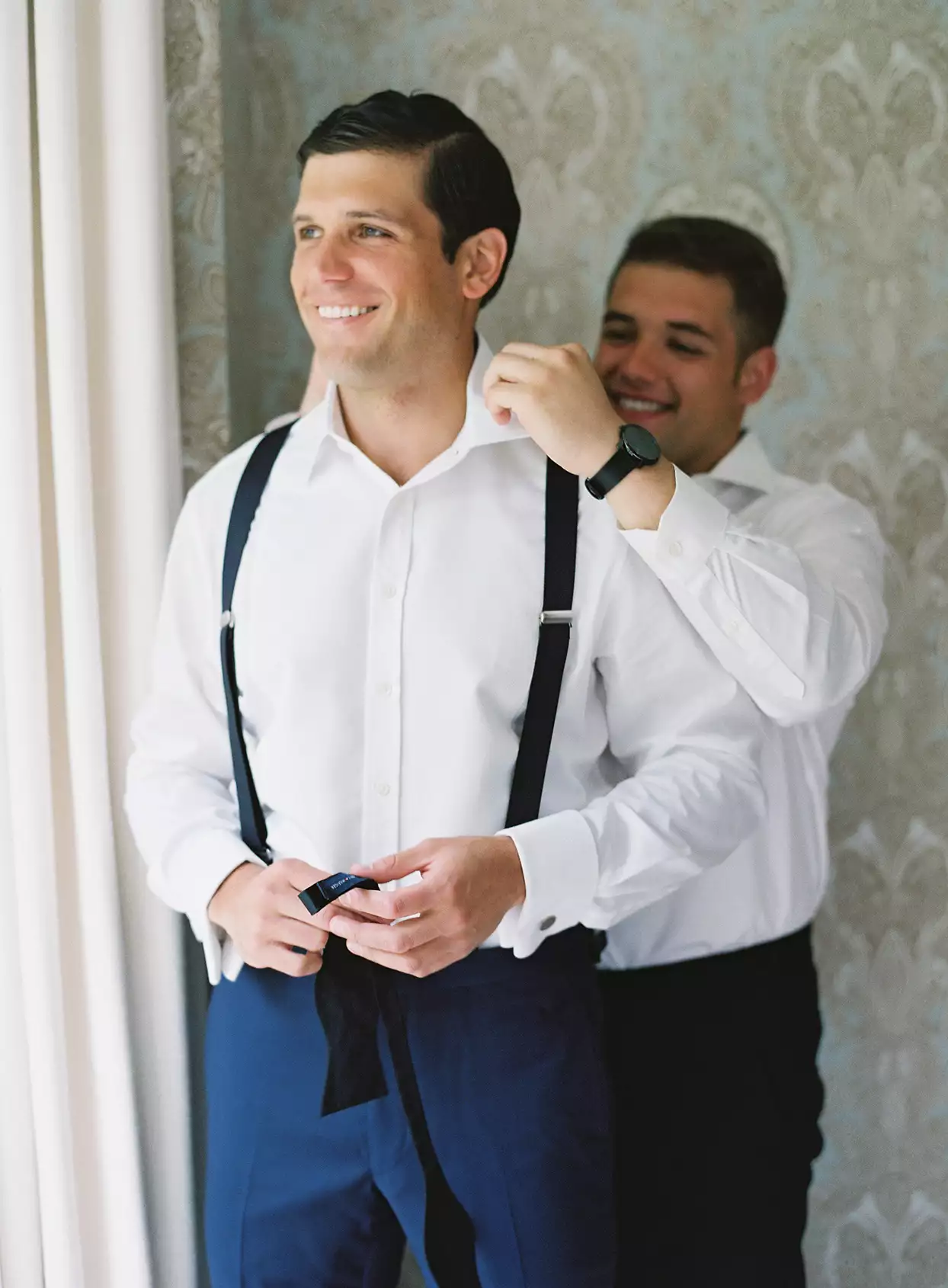 Should You Choose Your Brother as Your Best Man Straightening the groom's collar.