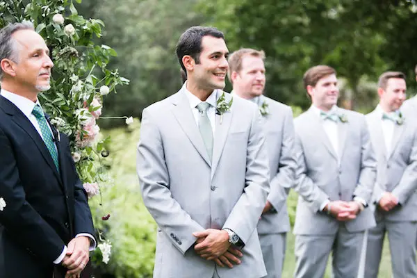 Groomsmen are standing behind the groom at wedding