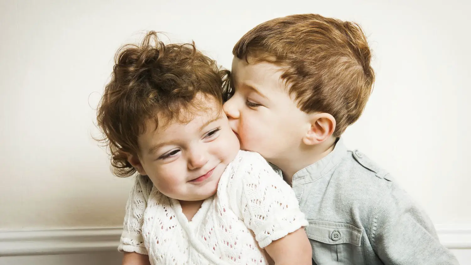 physical affection between siblings brother kissing his sister on cheek