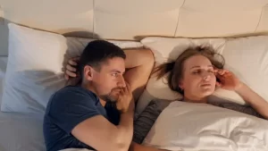 Wife sleeping and husband is watching